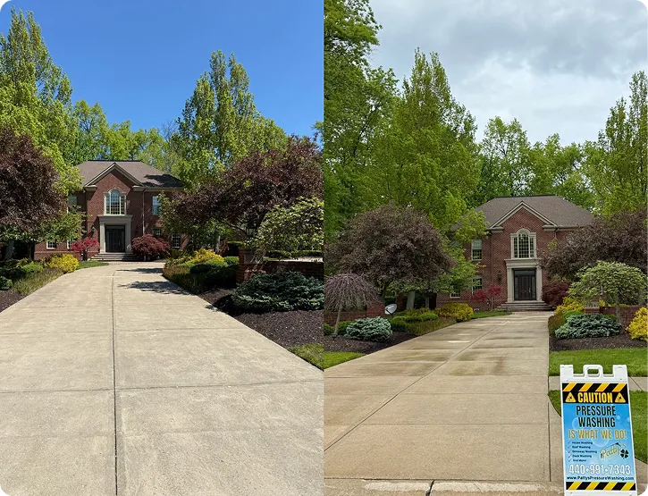 A long concrete driveway and front approach at a brick home, pressure washed by Patty's Pressure Washing