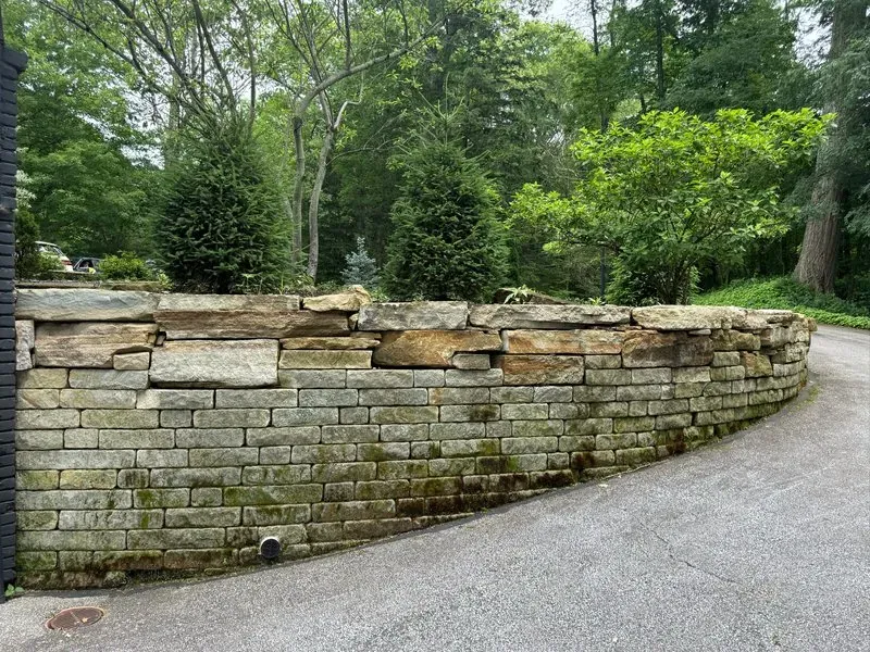 Stone retaining wall in Moreland Hills, Ohio, before cleaning