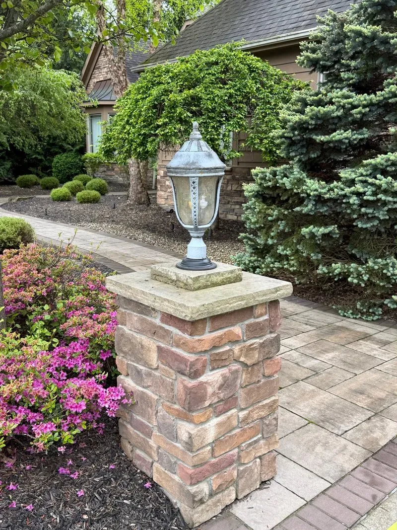 Stone pillar and lantern in Solon, Ohio, before cleaning