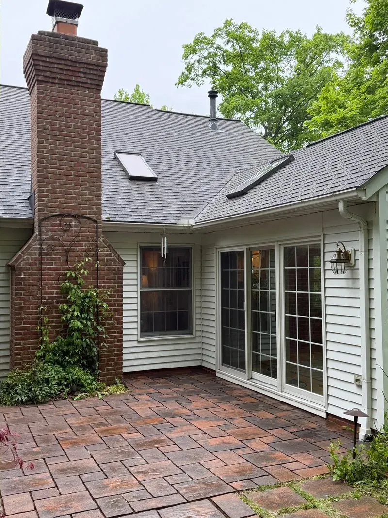 Brick chimney and paver patio in Chagrin Falls, Ohio, after cleaning by Patty's Pressure Washing