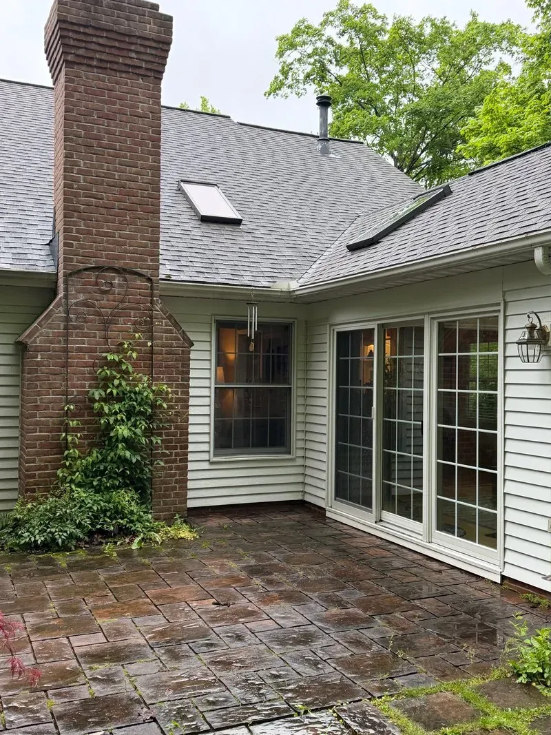 Brick chimney and paver patio in Chagrin Falls, Ohio, before cleaning
