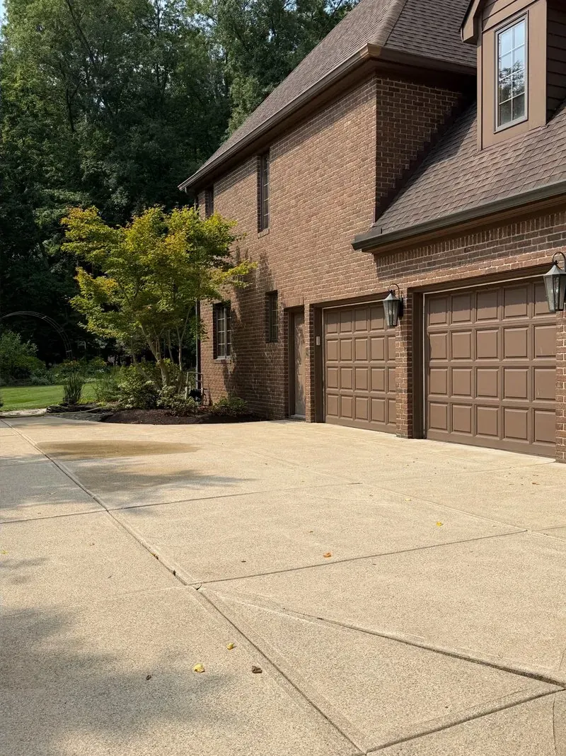 Concrete driveway and garage apron in Westlake, Ohio, after cleaning by Patty's Pressure Washing