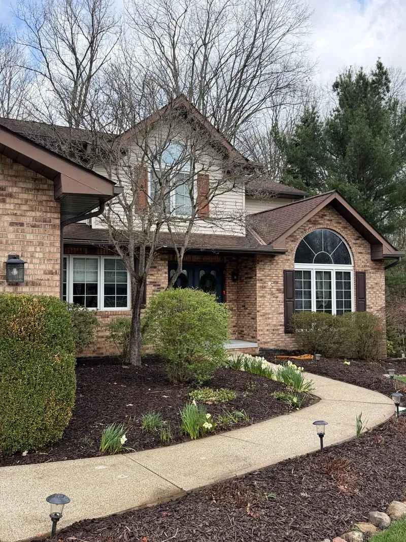 Brick facade and curved front walk in Valley View, Ohio, after cleaning by Patty's Pressure Washing