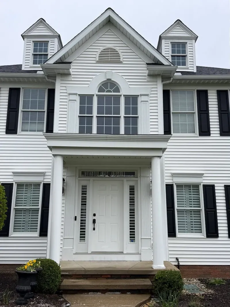 White colonial and portico in Chagrin Falls, Ohio, before cleaning