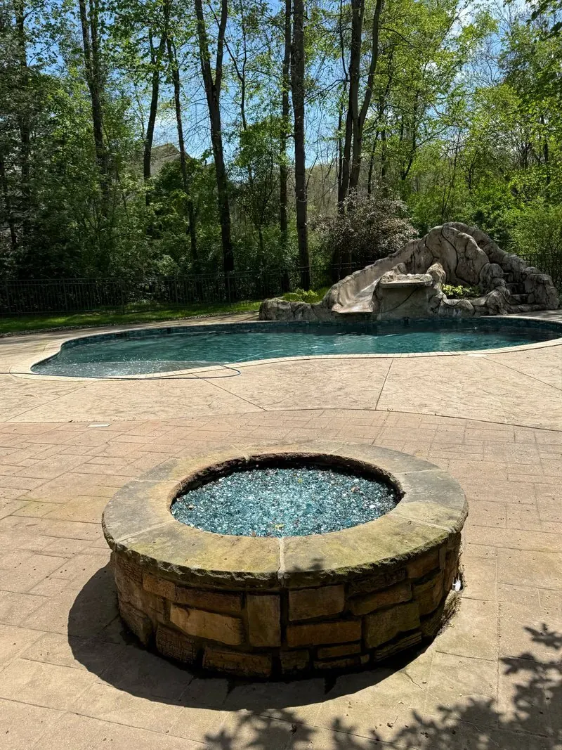 Fire pit and pool deck in Bentleyville, Ohio, before cleaning