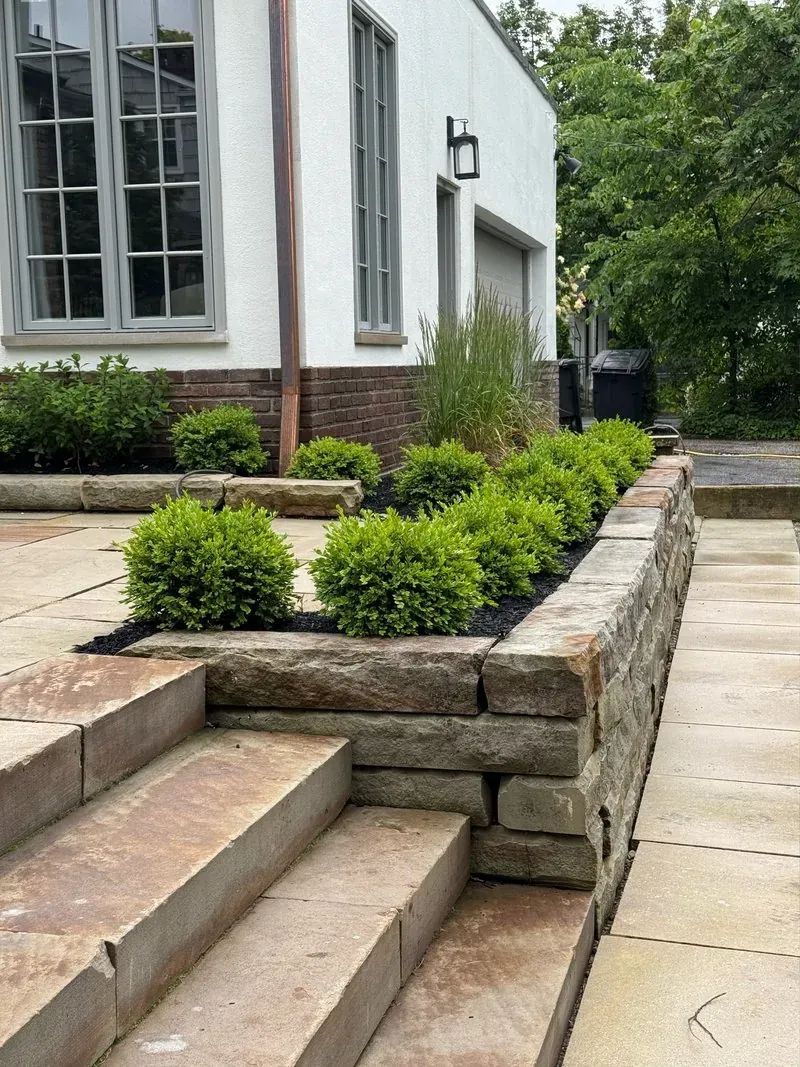 Sandstone retaining wall and steps in Beachwood, Ohio, before cleaning
