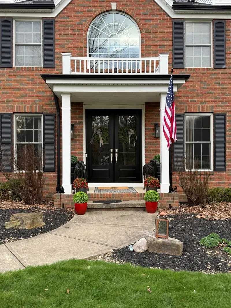 Brick entry and concrete front walk in Bainbridge Township, Ohio, before cleaning