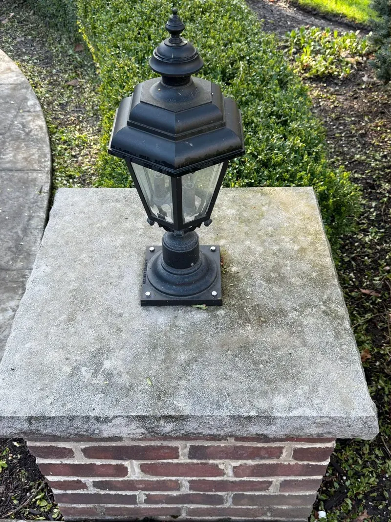 Brick pillar, stone cap and lantern in Bainbridge Township, Ohio, before cleaning