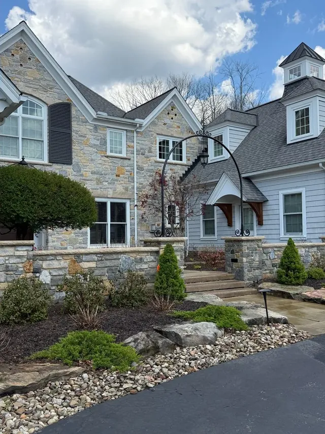 Stone house, garden wall and front steps in Bainbridge Township, Ohio, after cleaning by Patty's Pressure Washing