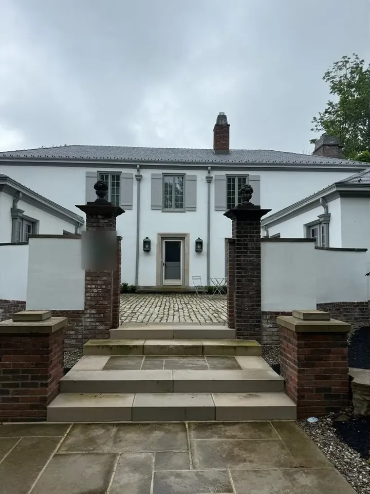 Sandstone entry steps and brick pier forecourt in Beachwood, Ohio, before cleaning