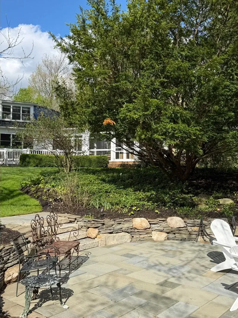 Bluestone patio and stone garden wall in Chagrin Falls, Ohio, after cleaning by Patty's Pressure Washing