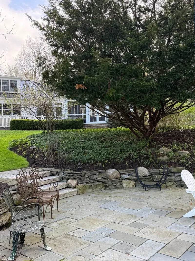 Bluestone patio and stone garden wall in Chagrin Falls, Ohio, before cleaning