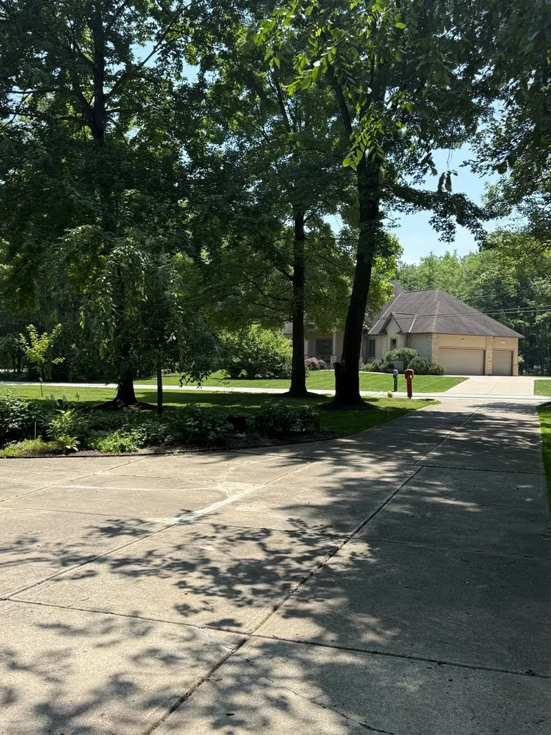 Long concrete driveway in Solon, Ohio, before cleaning